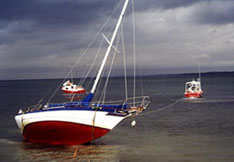 Hard-grounded boat being towed by a TowBoatUS towboat